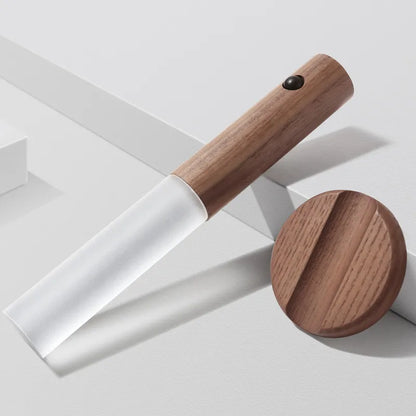 Wooden spatula with white blade on a light gray background